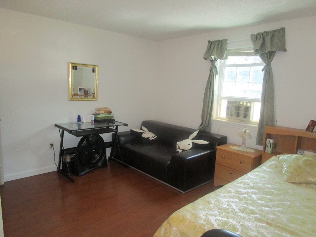 23 Oak Street, Unit E Methuen, MA 01844 - Photo 17 of 26 a living room with furniture and a window