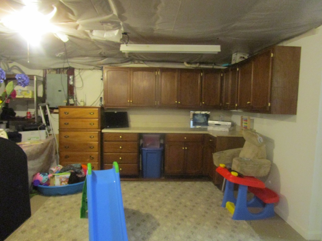 23 Oak Street, Unit E Methuen, MA 01844 - Photo 23 of 26 a kitchen with a refrigerator and a wooden cabinets