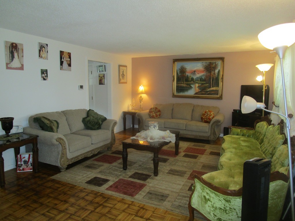23 Oak Street, Unit E Methuen, MA 01844 - Photo 8 of 26 a living room with furniture and a rug