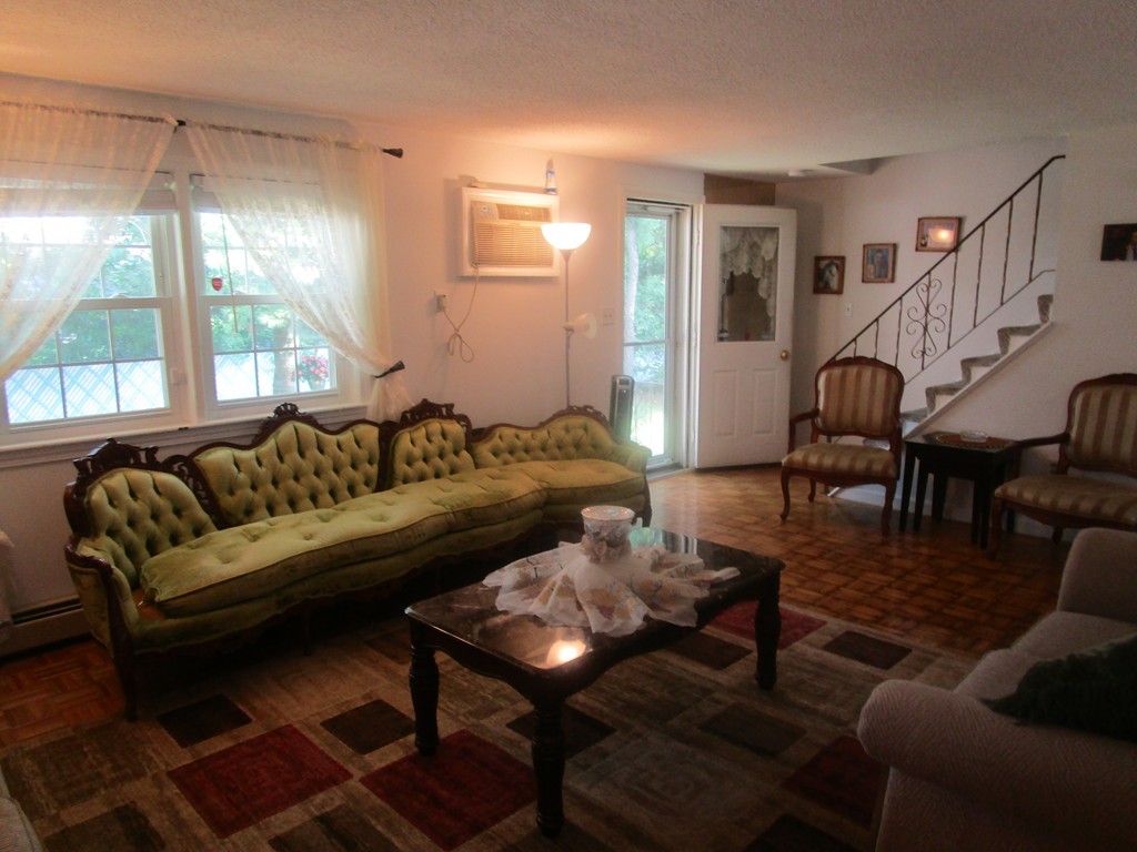 23 Oak Street, Unit E Methuen, MA 01844 - Photo 9 of 26 a living room with furniture and a table