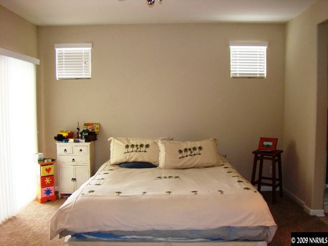 521 Needles Court Reno, NV 89521 - Photo 8 of 9 a bedroom with a bed and a dresser
