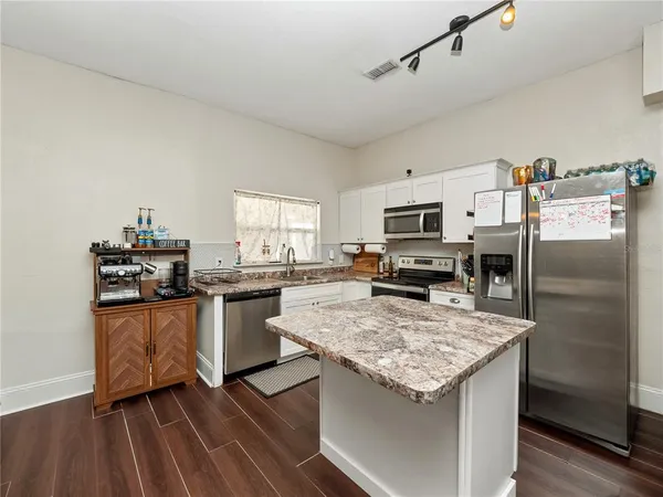 a kitchen with a stove sink and refrigerator
