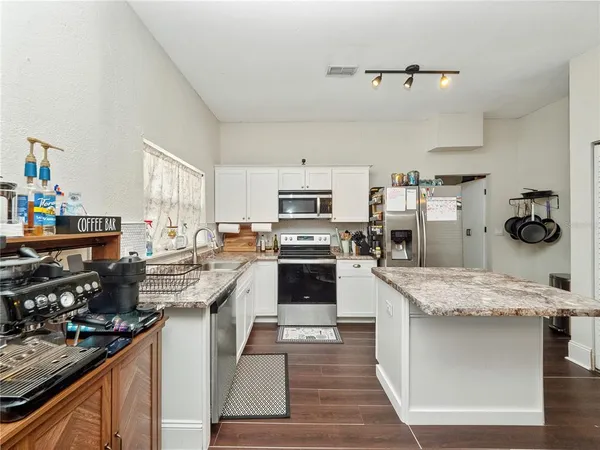 a kitchen with a sink stove and wooden cabinets
