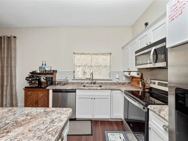 a kitchen with a sink stove and microwave
