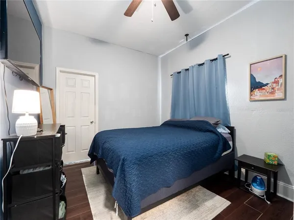 a bedroom with a bed and wooden floor