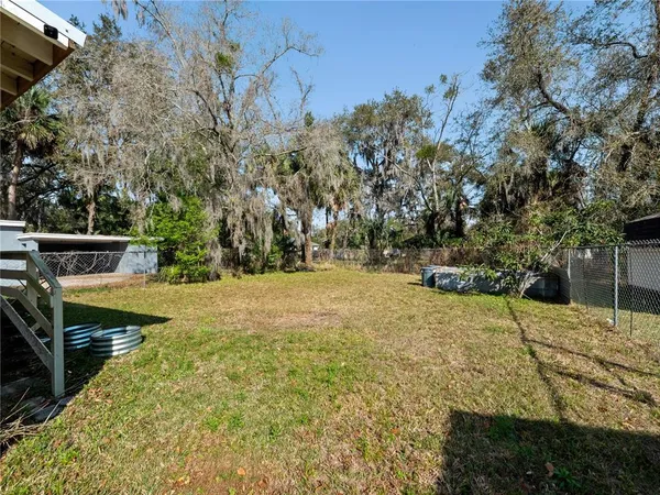 a view of yard with tree in the background