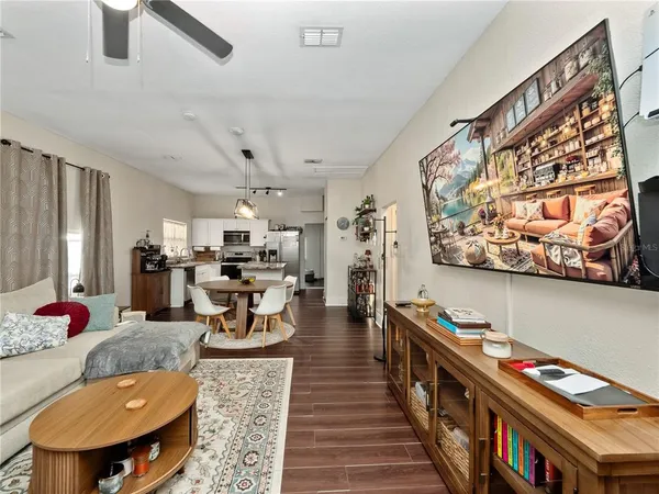 a living room with furniture and a book shelf