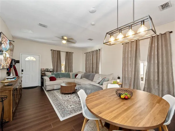a view of a dining room with furniture and wooden floor