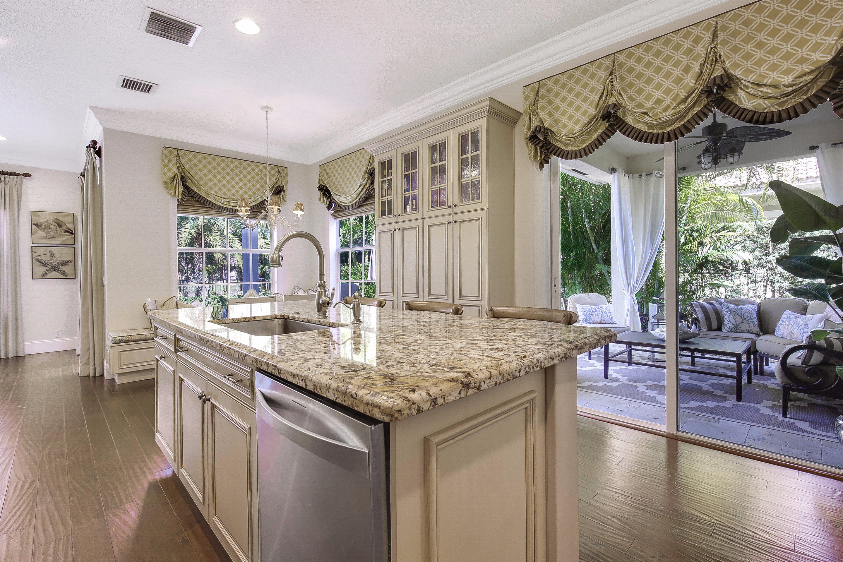 182 Via Veracruz Jupiter, FL 33458 - Photo 11 of 23 a kitchen with stainless steel appliances granite countertop a stove and a wooden floors