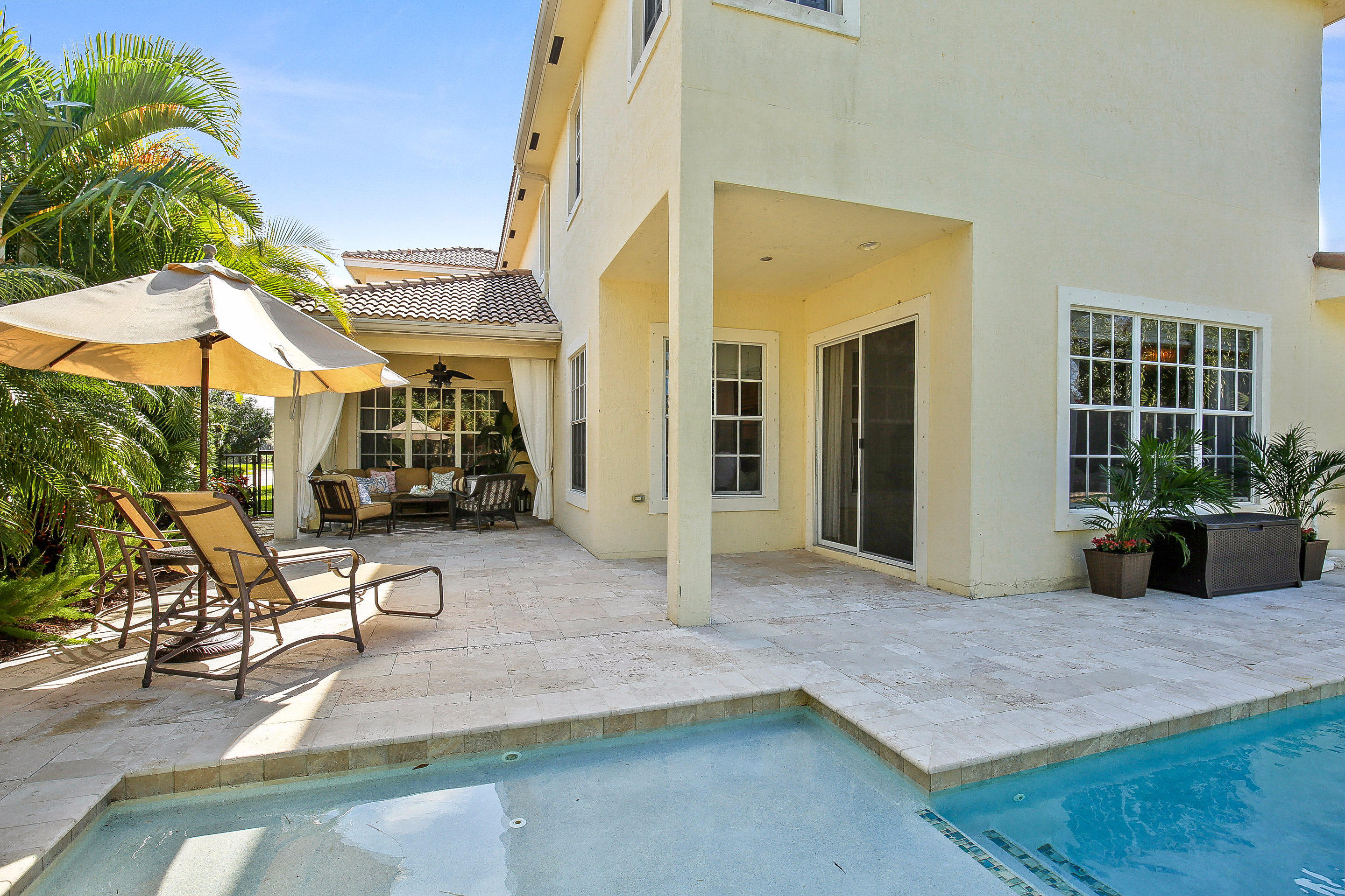 182 Via Veracruz Jupiter, FL 33458 - Photo 22 of 23 a view of a patio with table and chairs near a garden
