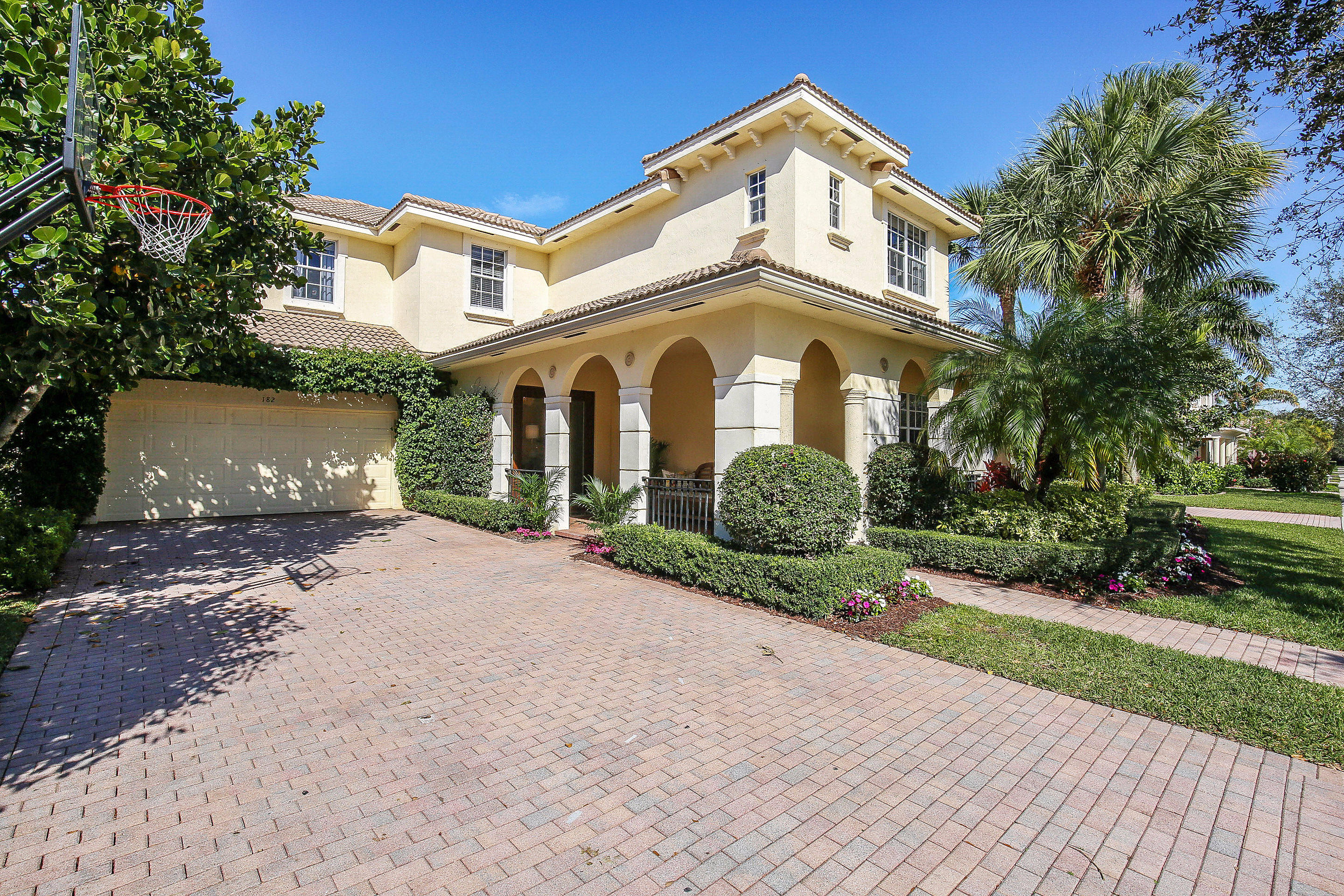 182 Via Veracruz Jupiter, FL 33458 - Photo 23 of 23 a front view of a house with a yard and a garage