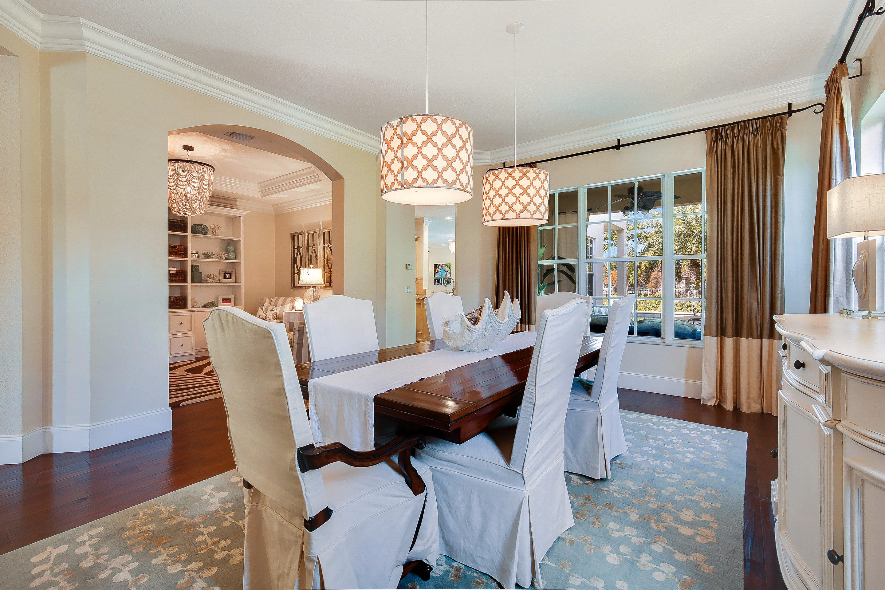 182 Via Veracruz Jupiter, FL 33458 - Photo 7 of 23 a view of a dining room with furniture window and wooden floor