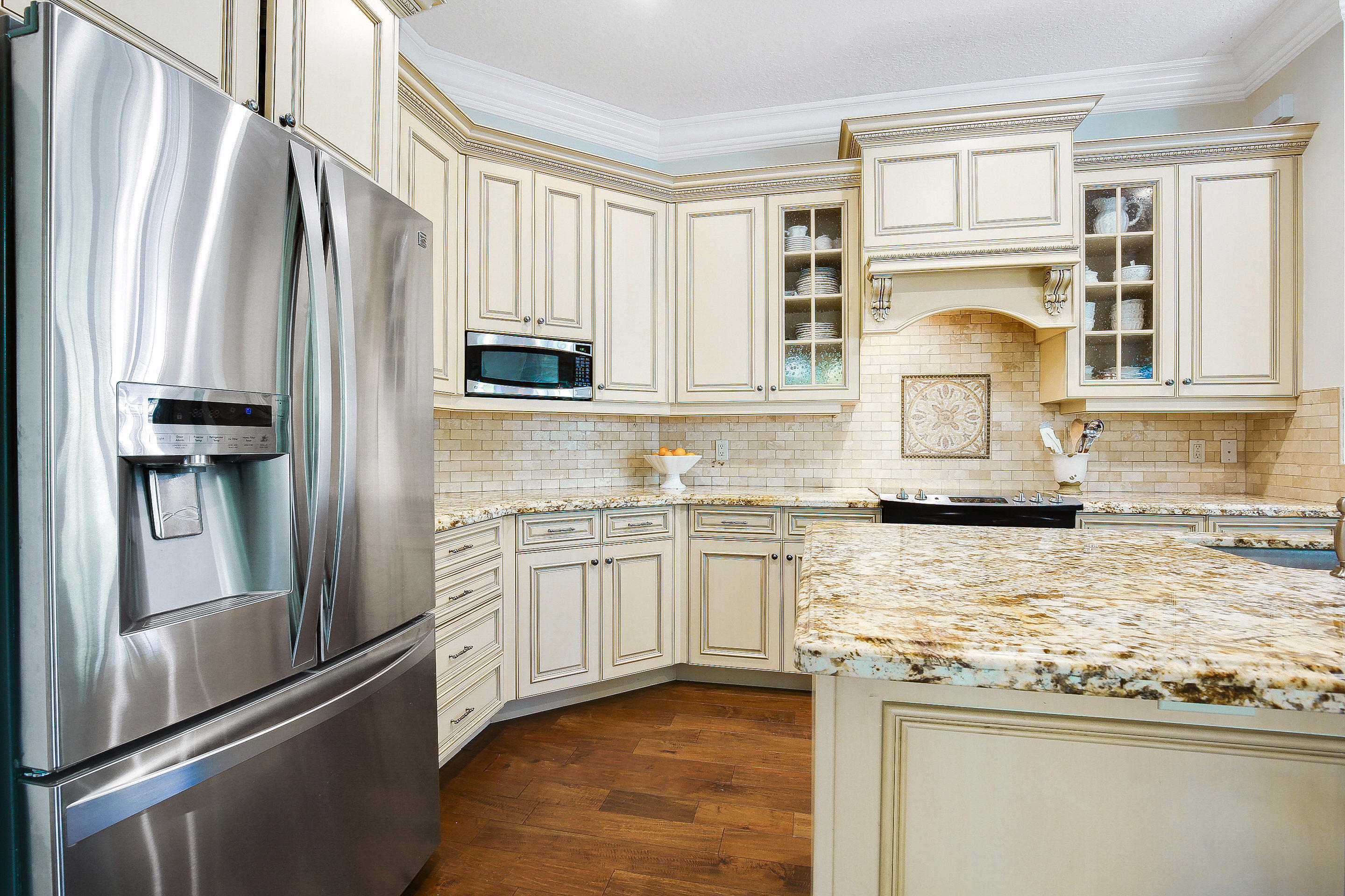 182 Via Veracruz Jupiter, FL 33458 - Photo 8 of 23 a kitchen with stainless steel appliances granite countertop a refrigerator a stove and a sink