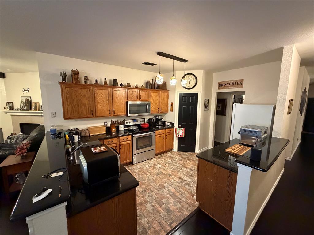 2531 Quail Ridge Road Melissa, TX 75454 - Photo 12 of 29 a kitchen with a refrigerator a stove top oven a sink and dishwasher