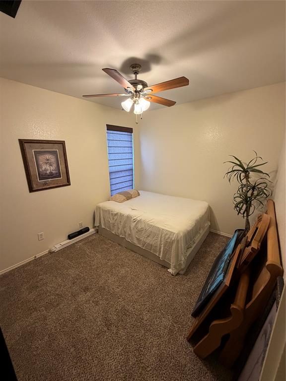 2531 Quail Ridge Road Melissa, TX 75454 - Photo 2 of 29 a bedroom with a bed and a chandelier