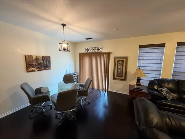 a work room with furniture and wooden floor