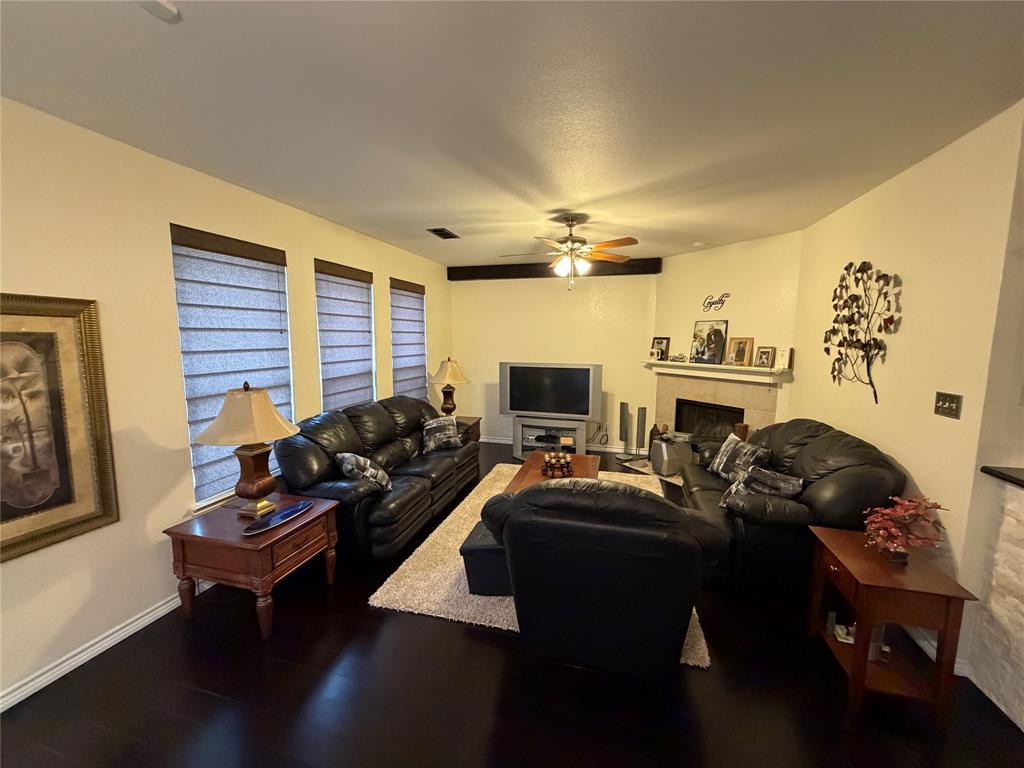 2531 Quail Ridge Road Melissa, TX 75454 - Photo 22 of 29 a living room with furniture a flat screen tv and a fireplace