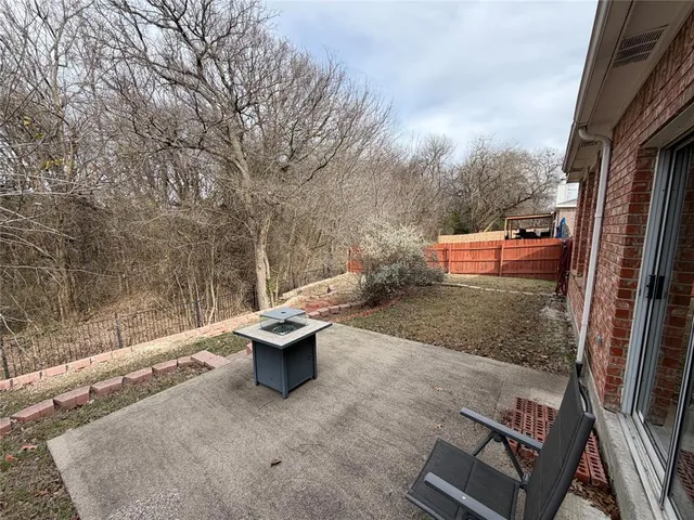 a backyard of a house with wooden floor and outdoor seating