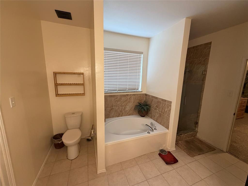 2531 Quail Ridge Road Melissa, TX 75454 - Photo 9 of 29 a white bath tub sitting next to a toilet