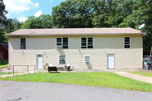 a front view of house with yard and trees