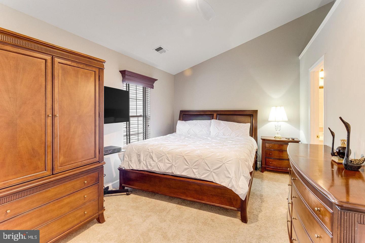14220 Madrigal Drive Woodbridge, VA 22193 - Photo 12 of 30 a bedroom with a bed and wooden floor