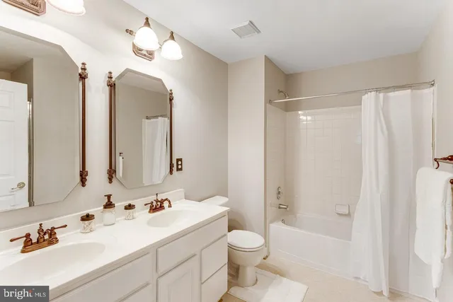 a bedroom with a bed and a flat tv screen on the table