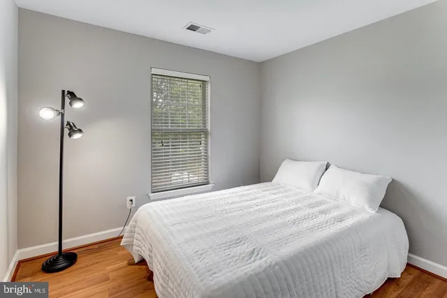 a bathroom with a bathtub shower sink vanity mirror and toilet