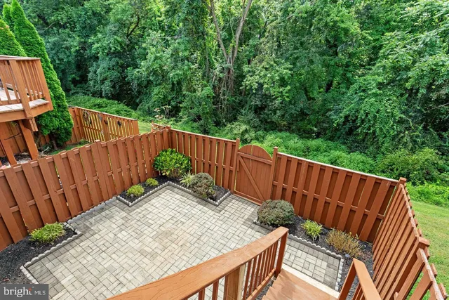 a sitting area with furniture and wooden fence