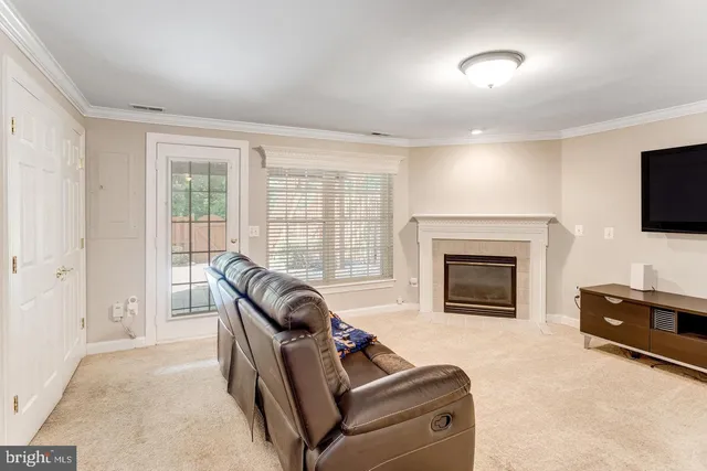 a living room with furniture fireplace and flat screen tv