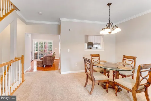 a living room with furniture a dining table and a flat screen tv