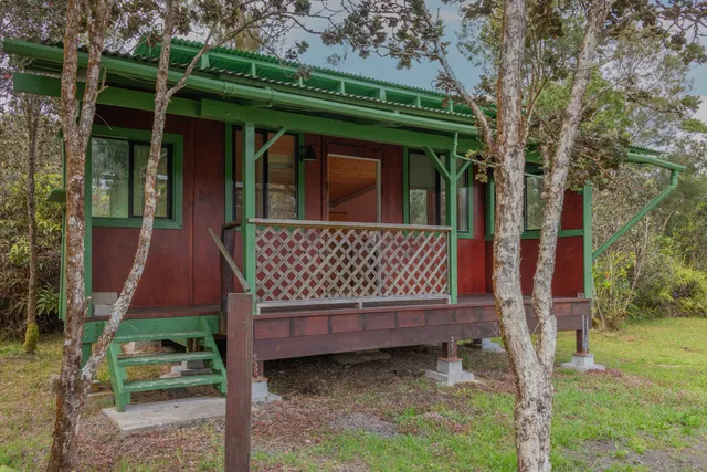 a view of a backyard with wooden fence