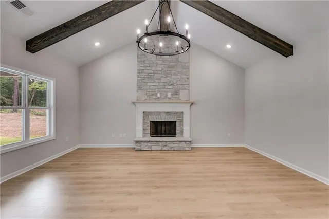 a view of large kitchen with a sink stainless steel appliances and cabinets