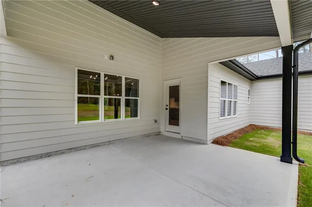 a view of a house with pool and chairs
