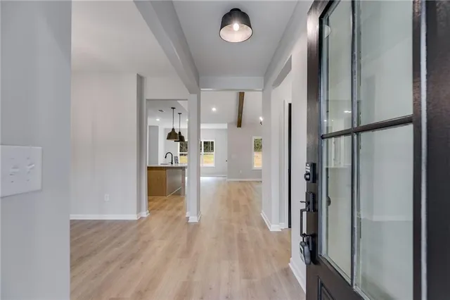 a view of wooden floor and chandelier in a room