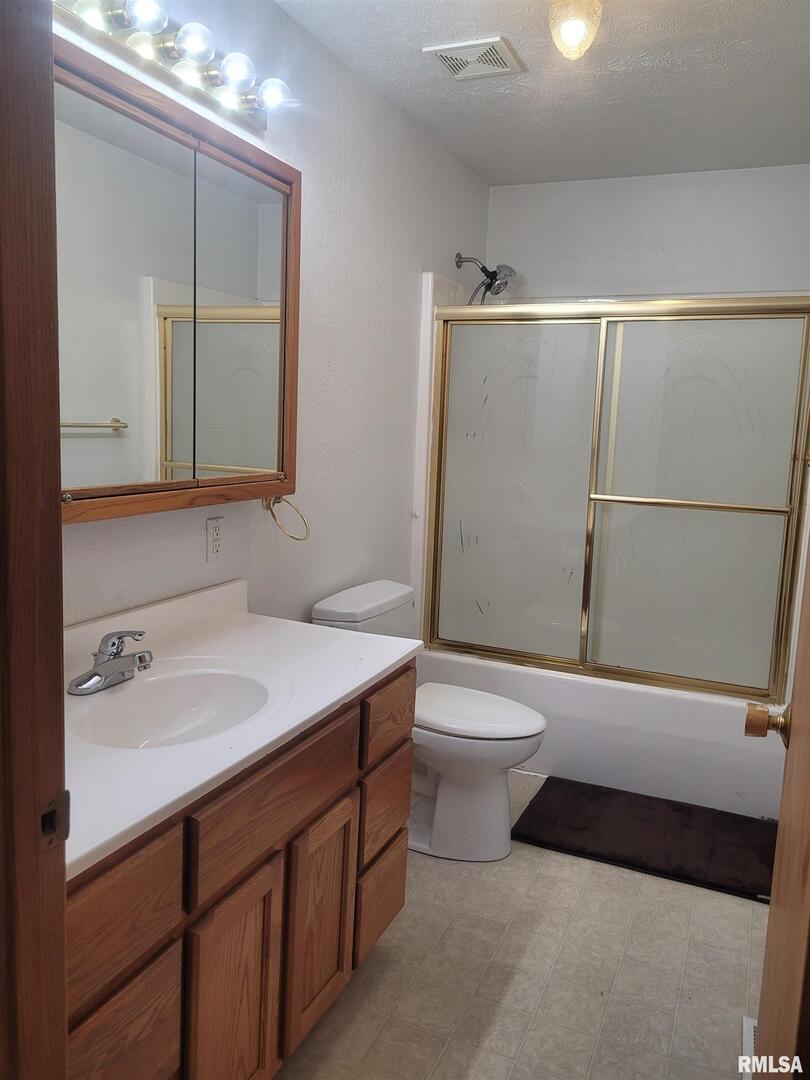 103 East Highline Road Woodlawn, IL 62898 - Photo 16 of 36 a bathroom with a sink a toilet and shower