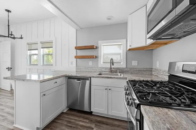 a kitchen with a sink stove and cabinets