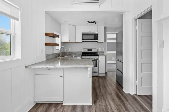 a kitchen with stainless steel appliances a sink stove and refrigerator