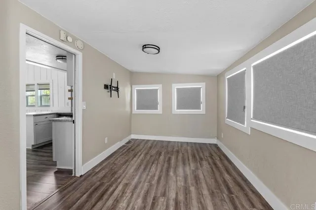 a view of a room with wooden floor and windows