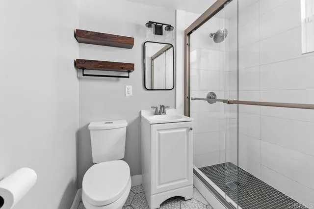a bathroom with a toilet a sink and mirror