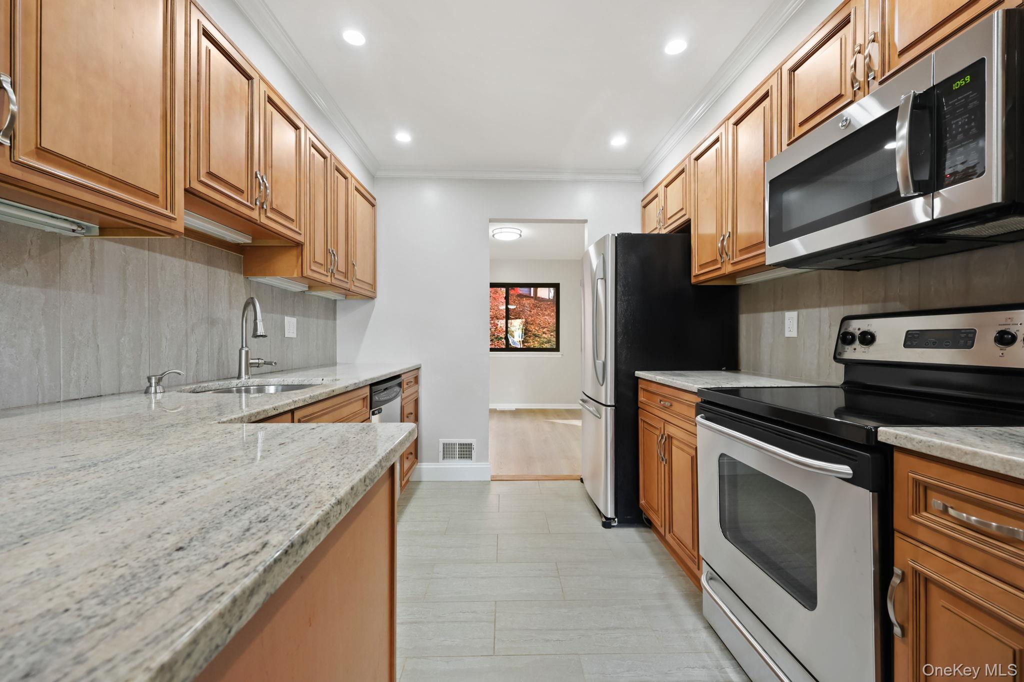 42 Timber Ridge Mount Kisco, NY 10549 - Photo 9 of 39 Updated Kitchen with granite counters, tile backsplash, crown molding and recessed lighting