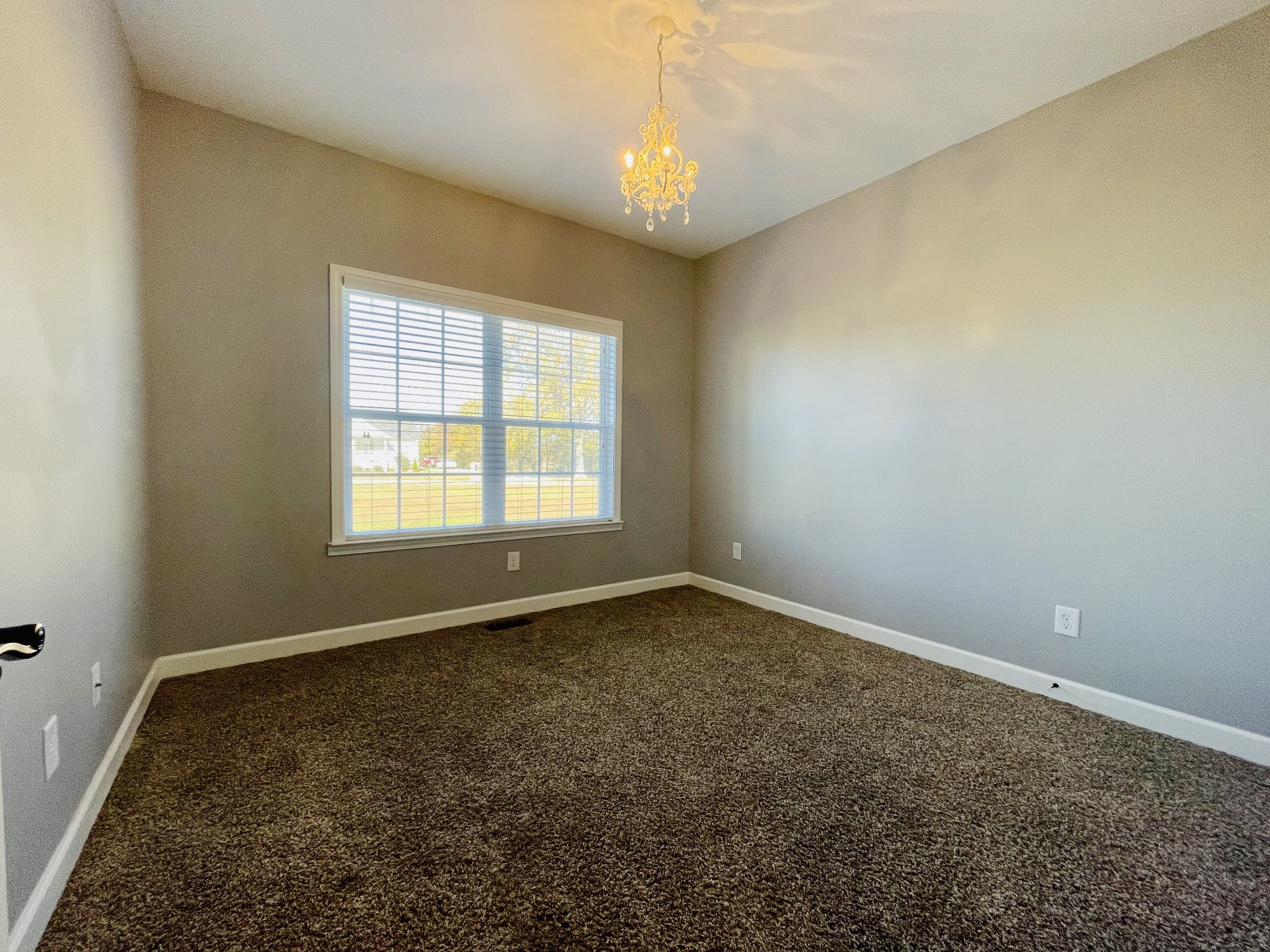 936 Jump Off Road Bon Aqua, TN 37025 - Photo 22 of 41 an empty room with a chandeliers