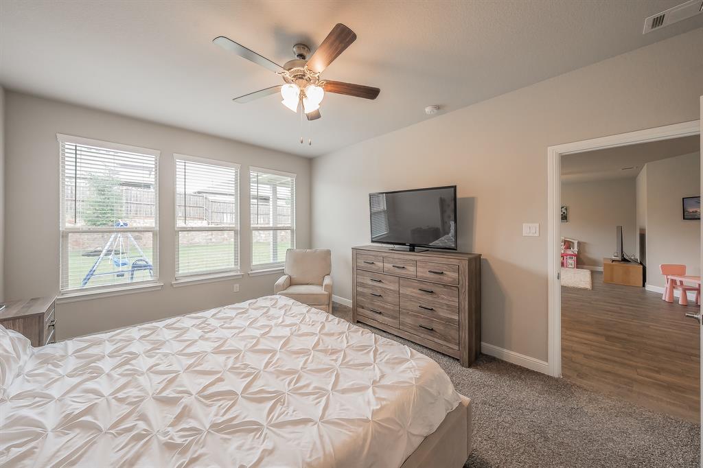 1212 Bosque Lane Weatherford, TX 76087 - Photo 27 of 38 a bedroom with a bed and a flat screen tv