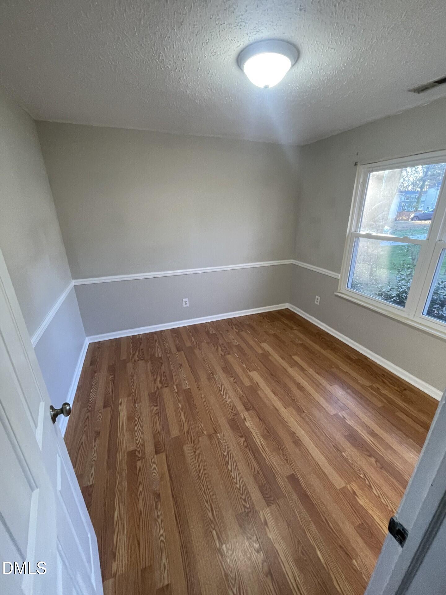 8920 Taymouth Court Raleigh, NC 27613 - Photo 18 of 20 a view of room with window and wooden floor