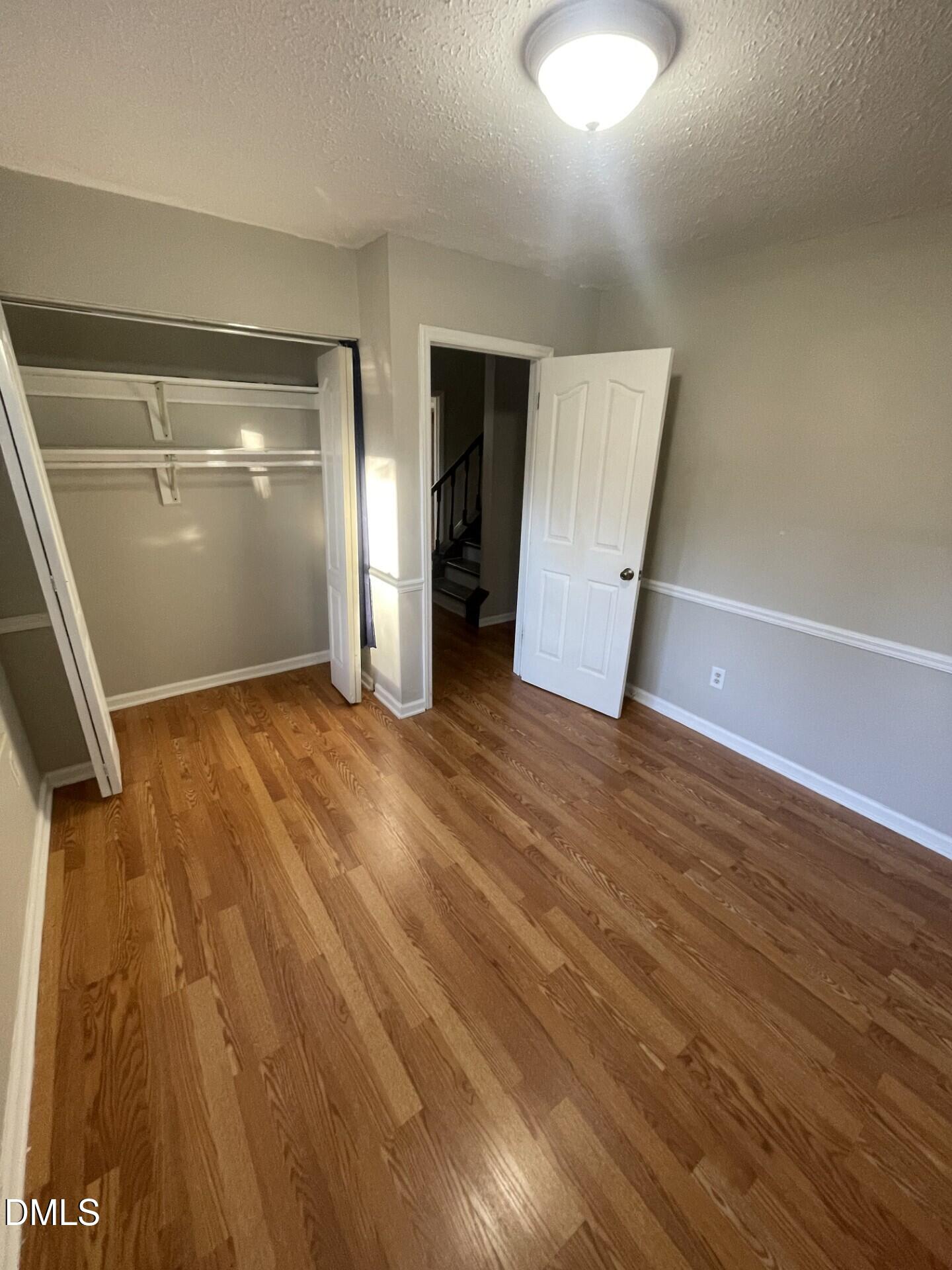 8920 Taymouth Court Raleigh, NC 27613 - Photo 19 of 20 an empty room with wooden floor and windows