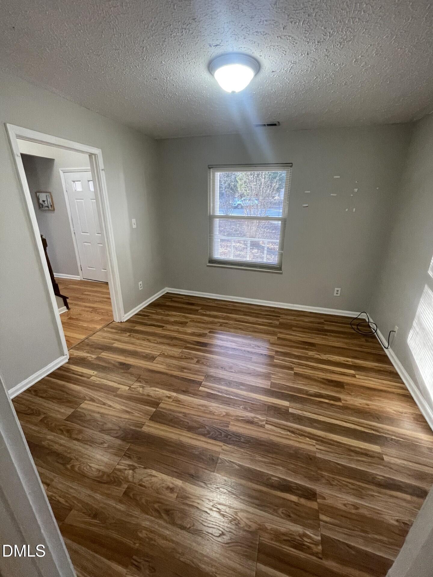 8920 Taymouth Court Raleigh, NC 27613 - Photo 8 of 20 an empty room with wooden floor
