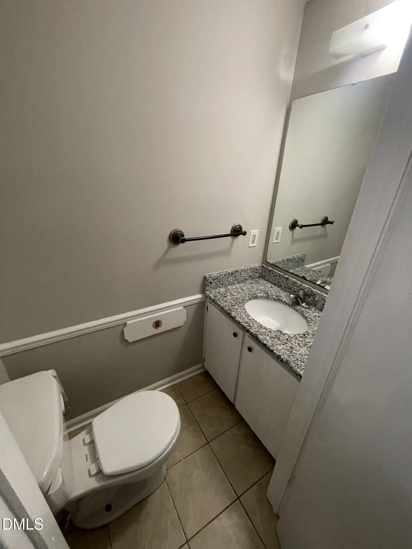 8920 Taymouth Court Raleigh, NC 27613 - Photo 10 of 20 a bathroom with a granite countertop toilet sink and mirror
