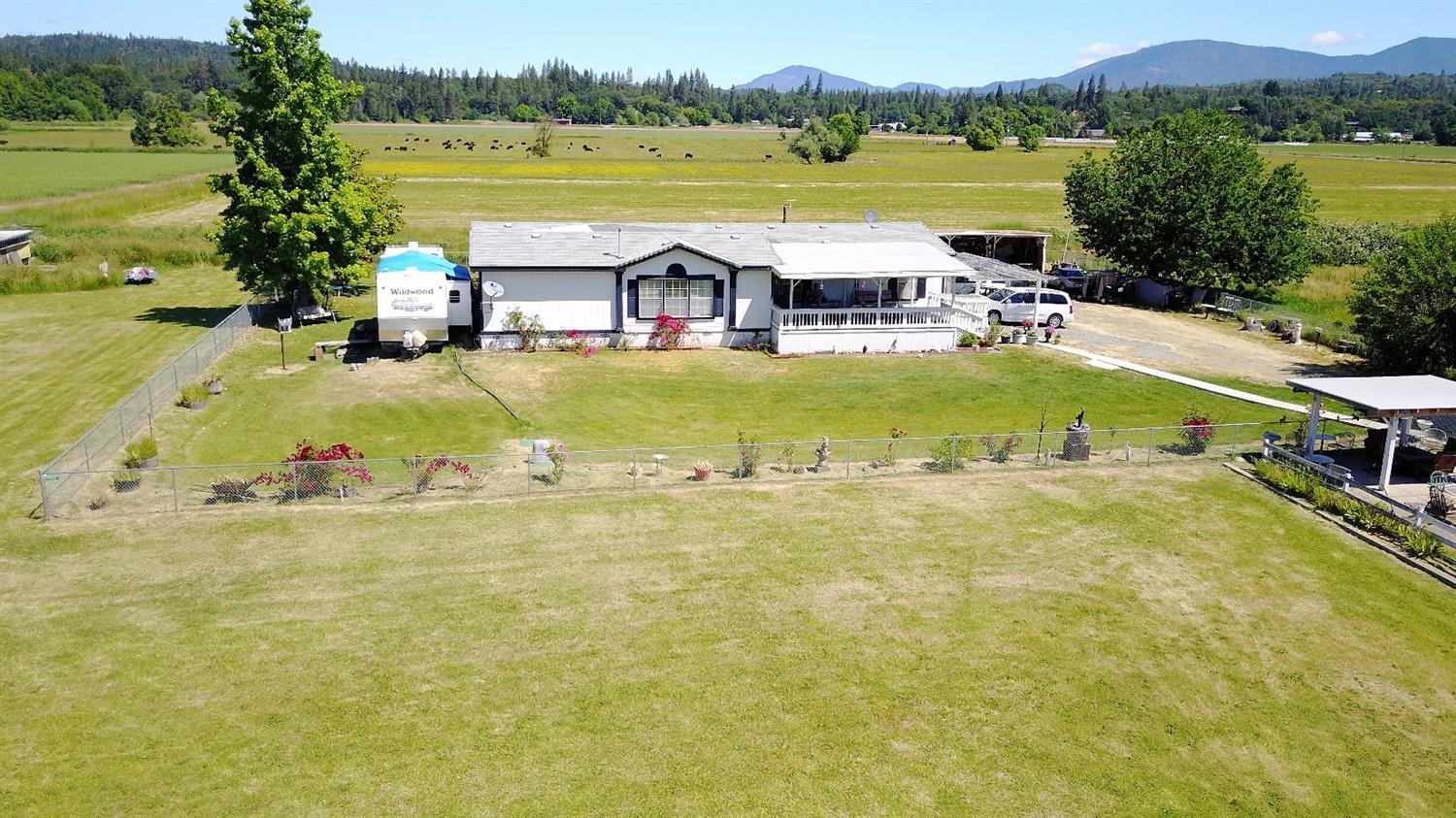 5390 Lower River Road Grants Pass, OR 97526 - Photo 3 of 35 a view of a swimming pool with a lake view