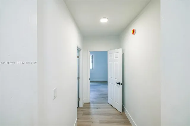a view of a hallway with wooden floor