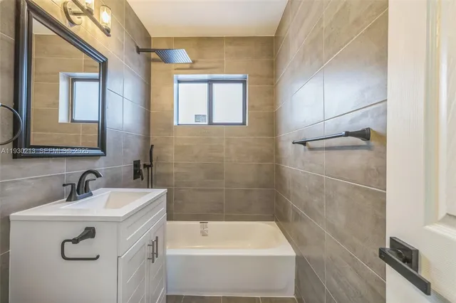 a bathroom with a sink a bathtub and a shower