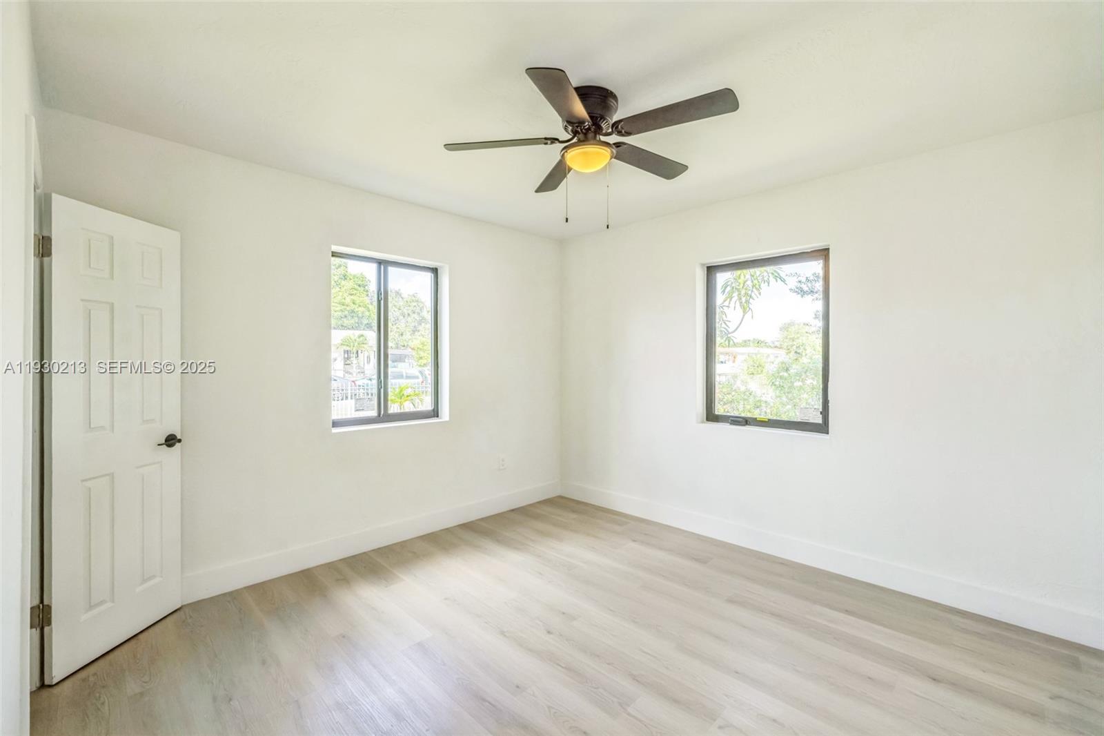 9055 Northwest 33rd Avenue Miami, FL 33147 - Photo 26 of 32 wooden floor in an empty room with a window